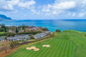 an aerial view of a golf course with the ocean at Hale Emmalani #311 condo in Princeville