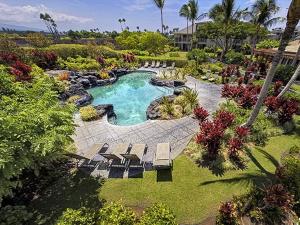 an aerial view of a swimming pool with chairs and a yard at Waikoloa Beach Villas O-33 condo in Waikoloa