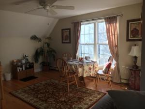 a dining room with a table and chairs and a window at Large Modern Private Suite by the Sea- Birders Paradise in Little Compton