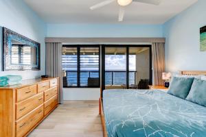 a bedroom with a bed and a large window at Poipu Shores 301B condo in Koloa +15 photos