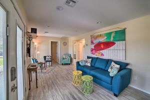 a living room with a blue couch and a table at Rockport Home with Yard 2 Mi to Gulf Coast Beaches! in Rockport