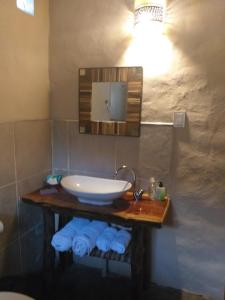a bathroom with a sink and a mirror and towels at Sendero De Las Cabras in Purmamarca +97 photos