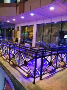a bar in a building with purple lights at Swiss Blue Hotel Al Zahra in Jeddah