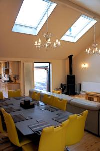 a dining room with a table and chairs and skylights at Hillside Lodge, Tor Farm in Cheddar