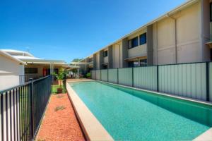 a swimming pool in front of a building at Weipa Motel Resort in Weipa