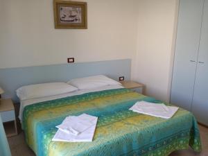 Postel nebo postele na pokoji v ubytování Long Beach Village Residence sul mare spiaggia privata inclusa