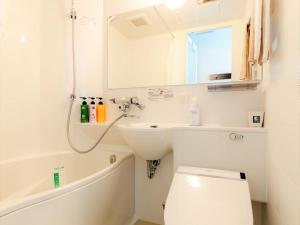 a bathroom with a toilet and a sink at APA Hotel Biwako Seta-Ekimae in Otsu