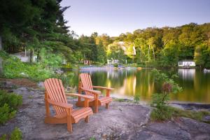 two chairs and a table in front of a lake at Sherwood Inn in Port Carling