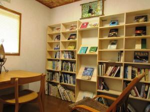 una biblioteca con estanterías llenas de libros en ポロト案内舎, en Hamanaka