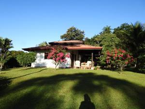 a person standing in front of a house in a yard at Casas Buenas Brisas in Ojochal