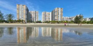 a view of a beach with tall buildings in the background at TIMURBAY KUANTAN SEAVIEW PLUS By Timurbay Arza in Kuantan