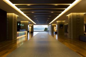 an empty hallway in a building with a large window at The Lake View Toya Nonokaze Resort in Lake Toya