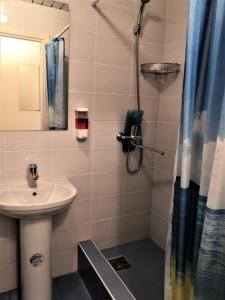 a bathroom with a sink and a shower at Гостиница Полет in Syktyvkar