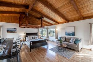 a living room with a couch and a table at Stunning Oceanview Coastal Home Beach Trails Family Activities in Montara