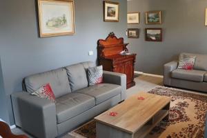 a living room with a couch and a table at Robinson Cottage in Oatlands