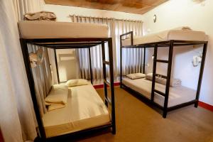 two bunk beds are in a room with a room with at Gaurishankar Backpackers hostel in Pokhara