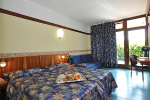 Postel nebo postele na pokoji v ubytování Park Hotel Oasi