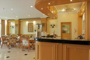a kitchen and dining room with a table and chairs at The Grand Dame Hotel in Iloilo City