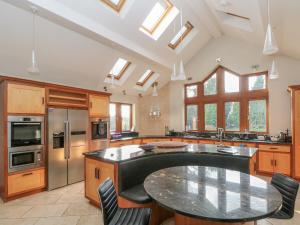 a large kitchen with a large black counter top at Manor House in Chesterfield