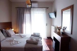 a bedroom with a large bed with a window at Double View Apartment in Agia Marina Nea Kydonias