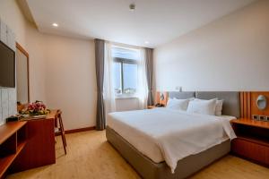 Postel nebo postele na pokoji v ubytování Bella Vita Hotel