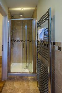 a shower with a glass door in a bathroom at Seascape in Aldeburgh