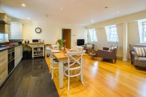 a kitchen and living room with a table and chairs at Seascape in Aldeburgh