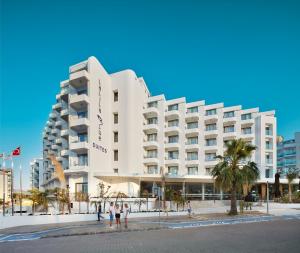 a hotel on the beach with people standing in front of it at Lalila Blue Suites in Marmaris