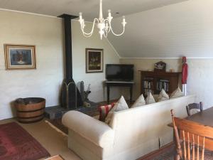 a living room with a couch and a fireplace at Inverknoll Guesthouse in Hilton