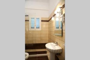 a bathroom with a sink and a toilet at Andreas Naxos Center - House in Naxos Chora