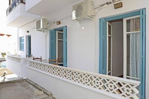 a balcony of a white building with blue windows at Andreas Naxos Center - House in Naxos Chora