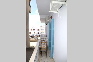 a row of chairs on a balcony of a building at Andreas Naxos Center - House in Naxos Chora +8 photos