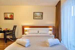 a bedroom with a bed and a desk in it at GVC New Gudauri in Gudauri