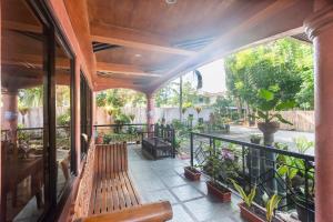 eine Terrasse mit Bänken und Pflanzen auf einem Balkon in der Unterkunft RedDoorz at Coco Grove Tourist Inn in Panglao