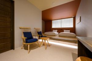 A bed or beds in a room at HOTEL WOOD TAKAYAMA