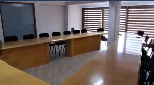 a conference room with a long wooden table and chairs at inn on mars in Pretoria +116 photos