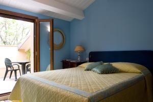 a blue bedroom with a bed and a table at Lo Squero Guest House in Fano