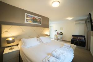 a bedroom with a large white bed with two pillows at Apartments Korta in Split