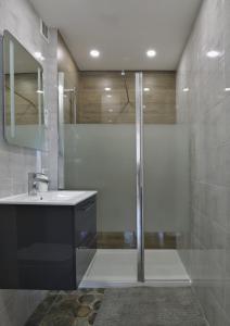 a bathroom with a shower and a sink at Amik apartament-Night View in Wrocław