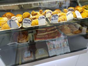 a bakery display case filled with different types of pastries at La Torre B&B in Avellino
