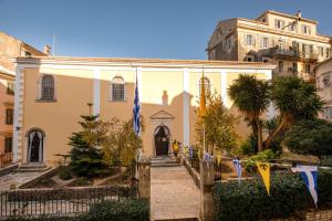 a building with flags in front of a building at San Nicolo dei Vecchi Casa by CorfuEscapes in Corfu Town