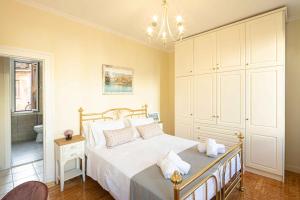 a bedroom with a large bed and a bathroom at San Nicolo dei Vecchi Casa by CorfuEscapes in Corfu Town