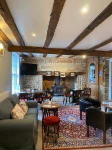 a living room with a couch and chairs and a fireplace at The Golden Boar in Newmarket