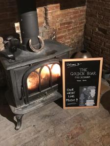a fireplace with a picture of a cat on it at The Golden Boar in Newmarket
