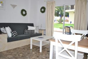 a living room with a couch and a table at Carihuela Park Palace - Cocasa in Torremolinos