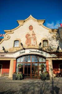 a building with a clock on the side of it at Hotel Nowodworski in Legnica