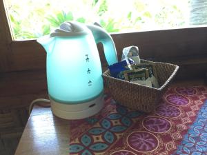 a blender sitting on a table with a basket of cookies at Villa Jati Mangsit in Senggigi