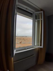 an open window with a view of a field at Les Embruns in Trouville-sur-Mer