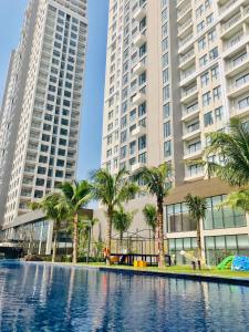 a pool in the middle of two tall buildings at Carinae Danang Hotel in Danang