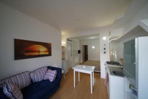 a living room with a couch and a table at Holiday home Isola Rossa in Isola Rossa